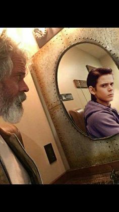 a man looking at himself in the mirror