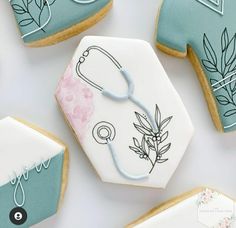 decorated cookies with medical stethoscope on them and some leaves around the cookie