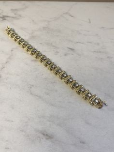 "18kt Yellow Gold Heavy Solid Lady's Cubic Zirconia (CZ) Bracelet 7\" in Length. This Bracelet consists of 18- 3mm, .10ct each , 1.80ctw Cubic Zirconia (CZ) all prong set in 14kt White Gold settings in a heavy solid 12mm wide hinged mounting. There is a hidden box clasp with a secure fig 8 safety clasp. These CZ's look so real. Total mounting weigh is 43.8 grams. This item would Retail for $6,550.00" Dazzling Gold Diamond Bracelet For Anniversary, Gold Sterling Silver Jubilee Bracelet With Cubic Zirconia, Yellow Gold Tennis Bracelet With Single Cut Baguette Diamonds, Yellow Gold Tennis Bracelet With Baguette Cut Single Diamonds, Yellow Gold Cubic Zirconia Bracelet For Anniversary, Gold Diamond Cut Bracelet With Dazzling Style, Gold Diamond Cut Dazzling Bracelet, Dazzling Gold Diamond Cut Bracelet, Gold Moissanite Diamond Bracelet With Brilliant Cut