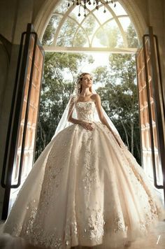 a woman in a wedding dress is posing for the camera