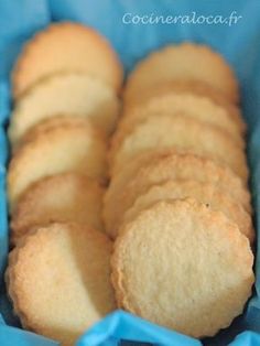 some cookies are in a blue box on top of a table and it looks like they have been cut into small pieces