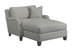 a gray chaise lounge chair with pillows on it