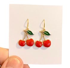 Cherry Earrings, Funny Earrings, Red Cherry Earrings, Miniature Fruit Earrings, Food Earrings, Weird Earrings, Funny Gift For Women Gorgeous Cherry Earrings that will look great with a lovely dress or jeans and t shirt. Handmade gold plated ear wires with gorgeous red enamelled Cherry charms and green enamelled leaves on gold plating. Perfect earrings for gifts or as a treat for yourself. 🍄 SIZE :approximately 3.5 cm drop. 🍄 MATERIALS: resin, gold plated wire, green and red enamel.  🍄 DESPATCH TIME: Posted next working day. 🍄Your Bonnie Wishes Jewellery will come wrapped in tissue paper with a lovely sticker and will be posted in a strong postal box to ensure your order reaches you in perfect condition. 🍄 I source premium quality jewellery findings worldwide, I use lead and nickel fre Trendy Enamel Drop Earrings, Red Enamel Trendy Earrings, Trendy Enamel Nickel-free Earrings, Trendy Nickel-free Enamel Earrings, Trendy Red Enamel Earrings, Cherry Colored Round Earrings For Gift, Cherry Round Earrings For Gift, Retro Enamel Earrings As Gift, Cute Red Enamel Earrings