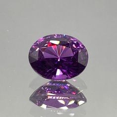 a purple diamond sitting on top of a table