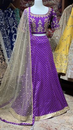 Purple bridesmaid lehenga With gold embroidery & stones! Fabric - Silk Color - Purple & Gold Our bridesmaid outfits can be customized in multiple colors and specific to client measurements. 90 days of production time is required and are for bulk orders! Wedding Dola Silk Lehenga, Dola Silk Lehenga For Wedding, Traditional Drape Wedding Sets With Dori Work, Reception Dola Silk Lehenga With Zari Work, Dola Silk Lehenga With Zari Work For Reception, Reception Lehenga With Zari Work In Dola Silk, Gold Lehenga With Resham Embroidery In Banarasi Silk, Gold Lehenga With Dabka Work, Gold Semi-stitched Gown With Dori Work