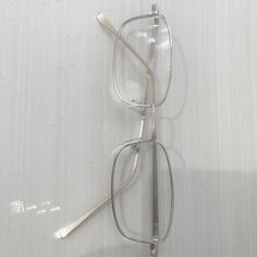 a pair of glasses sitting on top of a white surface