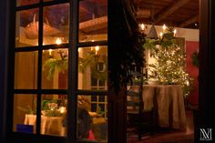 the inside of a house is lit up at night with christmas lights in the windows