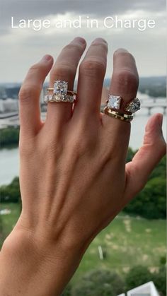 a woman's hand with two rings on it and the words large and in charge