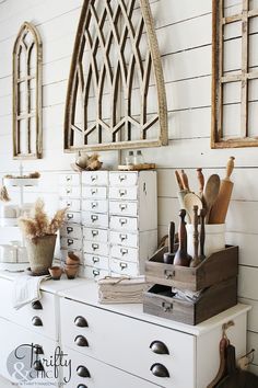 a white dresser with drawers and wooden utensils