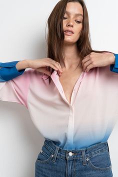 Add a touch of elegance to any outfit with this Pink White Blue Ombre Satin Blouse. Featuring a beautiful ombre print and hidden placket design, this long-sleeved top will make a statement whether paired with jeans or the matching ombre pants. With its extended cuffs, this blouse provides the perfect finishing touch. Fabric & fit: Model is wearing size Small. Ombre Pants, Placket Design, Ombre Print, Satin Blouse, Blue Ombre, Clothing Patterns, White Blue, Pink White, Long Sleeve Tops