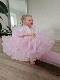 Introducing our incredibly puffy soft pink baby dress, specially designed to make your little one shine like a star! This enchanting dress features large puffy sleeves that add an adorable touch. The shiny fabric adds a delightful sparkle, making your little princess feel like royalty. Adorned with delicate 3D flowers and petals, this dress not only adds a charming touch but also creates a whimsical and dreamy look. Handcrafted with love, this dress is destined to make magical memories. Perfect for special occasions or simply creating picture-perfect moments, this dress is a must-have for your little fashionista. The dress can be sewn in such colors as white, ivory, light beige, light blue, delicate peach, blush, lavender, yellow. you can order a headband and booties as a set for the dress Pink Tulle Dress For Party Baptism, Cute Pink Princess Dress For Baptism, Pink Princess Dress For Baptism, Pink Organza Pageant Dress For Party, Sweet Pink Princess Dress With Ruffles, Princess Style Pink Pageant Dress For Baptism, Cute Pink Tutu Dress For Baptism, Pink Princess Pageant Dress For Baptism, Cute Pink Baptism Dress With Ruffles