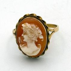 Along with the cameo pin my father bought for my mother on their first trip to Naples, Italy in 1984, he also bought her this pretty cameo ring. It is 18K gold and the cameo is set into a ruffle-edged bezel. The carved shell portrait is flawless and very pretty, not odd like some small cameo sculptures can be! The color is a traditional coral, and the cameo itself is more ivory than bright white. What make this cameo really special, besides the fact that it was hand made in Italy, is that mom wants to share it with the world. She can no longer slip it over her 85-year-old knuckles. But more importantly, she wants a special person to own this special gift from my dad and wear a little bit of their history together long into the future. In my family, we believe antiques should live on and be Shell Portrait, Long Slip, Naples Italy, Cameo Ring, Carved Shell, My Father, My Mother, Special Person, Ring Size 7