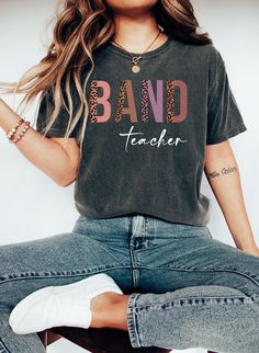 Comfort Colors Band Teacher T-shirt, Custom Teacher Shirt, Gİft for Her, Band Squad T-shirt, Band Teacher Gift, Retro Teacher Tee Shirt https://toptrendtshirtsus.etsy.com NOTE: Please contact me for more size,color, product (sweatshirt, hoodies,kids etc) options. I'm always here to help. Unisex Garment-Dyed T-shirt Comfort Colors® 1717 *Medium fabric (6.1 oz/yd² (206.8 g/m *Relaxed fit *Sewn-in twill label *100% ring-spun cotton About Comfort Colors introduces its garment-dyed t-shirt; a fully c Band Teacher Gifts, Teacher Tee Shirts, Band Teacher, Art Teacher Gifts, Squad Shirt, Team Shirt, Band Shirt, Color Bands, Teacher Tees