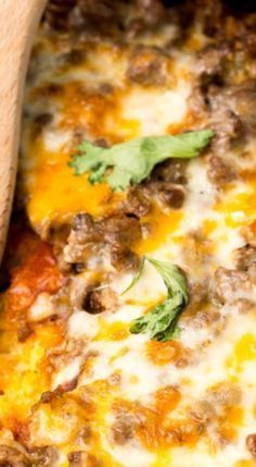 a close up view of a pizza with meat and cheese on it, in a casserole dish