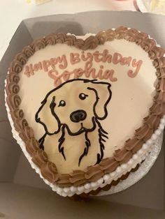 a cake shaped like a heart with a dog on it