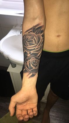 a man with a rose tattoo on his arm