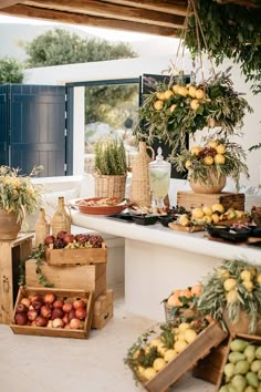 a table filled with lots of different types of fruits and vegetables on top of wooden crates