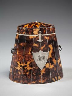 an old fashioned lamp shade with initials on the front and bottom, in tortoise shell