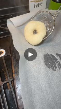 a donut is being cooked on the grill with a frying pan in front of it