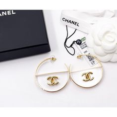 Chanel Brand New Gold CC Transparent Large Hoop Earrings * Marked 23 * Made in Italy *Comes with the original dustbag, pouch, tag, booklet, ribbon and tag – It is approximately 2″ x 2″. – Brand New 13298-1243  Please see the measurements section for best approximate dimensions. Designer White Earrings For Party, Designer White Earrings For Evening, White Hoop Earrings For Evening, Luxury White Hoop Earrings For Evening, White Luxury Hoop Earrings, Luxury White Round Hoop Earrings, Chanel Brand, Large Hoop Earrings, Vintage Cartier Bracelet