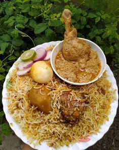 a white plate topped with rice and meat