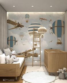 a baby's room with hot air balloons painted on the wall and wooden furniture