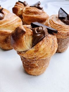 several pastries with chocolate frosting on them