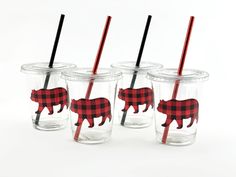 four glass cups with red and black buffalo silhouettes on them, one has a straw in it