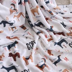 a white blanket with dogs printed on it