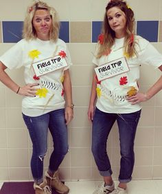 two women standing next to each other wearing t - shirts with words field trip on them