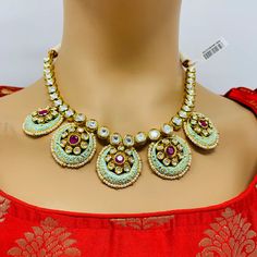 Description: Elevate your outfit with our Designer Gold Plated Royal Kundan & Ruby Necklace with Earrings. Made with high-quality materials, this luxurious set exudes elegance and sophistication. The intricate design and stunning ruby stones will make you stand out from the crowd. Perfect for any special occasion, this set will add a touch of royalty to your look. Exotic and snag-free kundan beaded necklace set with earrings. This set will work well with traditional, formal, and western formals. Western Formals, Saree Petticoat, Necklace Set With Earrings, Silver Pooja Items, Glass Bangles, Silver Toe Rings, Gold Chain With Pendant, Kundan Earrings, Ruby Necklace