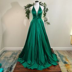 Beautiful And Brand New Emerald Green Ballgown With Plunging Neckline. Style 2183 And Made By Colors Designer. Green V-neck Maxi Dress With Sweep Train, Green V-neck Dress For Homecoming, Green Homecoming Gown With Sweep Train, Green Satin Gown For Homecoming, Green Gown With Sweep Train For Homecoming, Green Sleeveless Maxi Dress For Homecoming, Green Full-length Dress With Sweep Train, Green Full Length Dress With Sweep Train, Green V-neck Gown For Prom Season