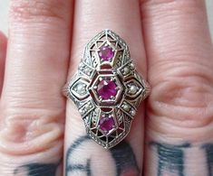 **IMPORTANT!! This ring is made to order! It has a 1-2 week delivery time!! I will ship it asap This is a gorgeous Ring, perfect as a treat for yourself, or a gift from your partner! *wink *wink!♥ A lovely detailed filigree design holds 3 natural rubies in prong settings, and 10 tiny seed pearls in two different sizes! The quality of this piece is impeccable, and the detail is amazing! Light comes through the back side of the rubies to show of their clarity and dark pink color! Cast from an auth Handmade Sterling Silver Art Deco Rings, Handmade Art Deco Sterling Silver Rings, Handmade Art Deco Jewelry For Anniversary, Art Deco Ring With Accent Stones For Gifts, Art Deco Ring With Accent Stones Gift, Art Deco Rings With Accent Stones For Gifts, Art Deco Hallmarked Ruby Ring For Gift, Vintage Rings With Stones For Anniversary, Vintage Anniversary Rings With Stones