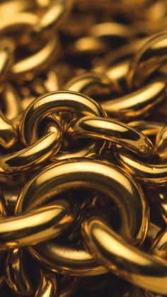 gold chains are stacked together in this close up photo