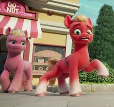 the pink pony is standing in front of two other toy ponies on the sidewalk