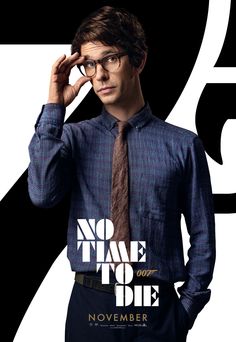 a man with glasses and a tie is standing in front of a poster that says, no time to die