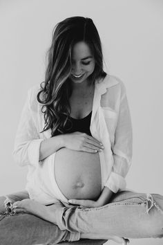 a pregnant woman sitting on her stomach