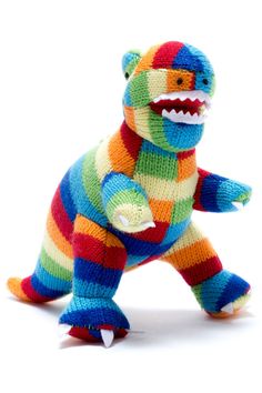 a colorful stuffed animal that looks like a t - shirt monster with teeth and fangs