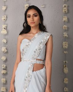 Description: The Classic Silhouette of a saree in ice blue, overlaid with whimsical details of a floral trellis border of hues of cream and silver. The saree is paired with a plain corset tube top blouse and embroidered belt.Colour Ice blueFabric GeorgetteCare Dry Clean onlyFit Tailored*Please note: The belt is included in the outfit Light Blue Pre-draped Saree For Wedding, Light Blue Fitted Saree Traditional Drape, Silver Pre-draped Saree With Sheer Dupatta, Fitted Silver Pre-draped Saree For Designer Wear, Elegant Light Blue Saree With Cutdana, Bollywood Style Pre-draped Saree In Light Blue, Fitted Light Blue Blouse Piece For Wedding, Elegant Light Blue Saree With Resham Embroidery, Elegant Light Blue Choli For Festive Occasions