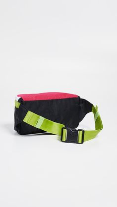 Perfect for giving your off-the-clock looks an instant does of street style, this PUMA fanny pack stands out from the crowded field of belt bags with sporty and vibrant colorblocking. DETAILS Fabric: Technical weave Rubber zip tassels Logo patch Zip at top Lined Weight: 5oz / 0.14kg Imported Measurements Height: 4.25in / 11cm Length: 13.5in / 34cm Depth: 3.5in / 9cm Belt length: 26.75-42.25in / 68-107cm Sporty Nylon Belt Bag For Sports, Sporty Belt Bag For Outdoor Activities, Sporty Nylon Belt Bag For Streetwear, Functional Multicolor Bags For Streetwear, Sporty Green Belt Bag For Travel, Casual Multicolor Belt Bag For School, Multicolor Sporty Bags For Sports, Functional Pink Bags For Streetwear, Sporty Belt Bag For Travel