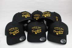 black and gold baseball caps with white brimmed visor, one for each team