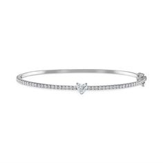 This beautiful bangle is the perfect everyday basic with a twist. Available in 14K White Gold, Yellow Gold, or Rose Gold Pave Diamond weight = 0.70 carats Heart weight = 0.30 carats Bangle width = 1.7mm Wrist sizes: XS = 15 to 16cm; Small = 17cm The bangle is oval-shaped and has a side closure with figure-8 clasps Please contact us for custom sizes or layouts Classic White Gold Bangle With Single Diamond, Classic Round Diamond Heart Bracelet, Classic Diamond Heart Bracelet, Classic Diamond Heart Bracelet In White Gold, Classic White Gold Diamond Heart Bracelet, Classic Bangle With Single Diamond For Anniversary, Classic Single Diamond Bangle For Anniversary, Timeless Single Diamond Bangle For Anniversary, Classic Single Diamond Bangle For Wedding