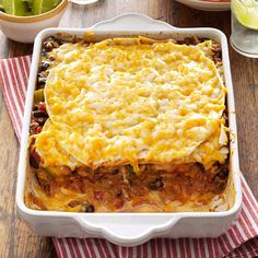 a casserole dish with meat and cheese in it on a red and white towel