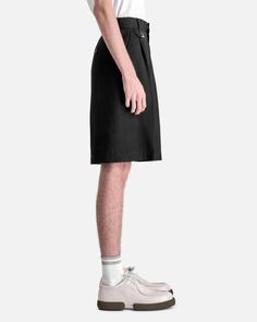 Jacquemus le short melo in black. these shorts feature a zip fly and button closure j-tab loop on the waist front pleats and 3-pocket styling. Mens Shorts, Black