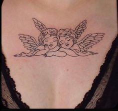 a woman's chest with an angel tattoo on the back of her breast and two cherubs holding each other