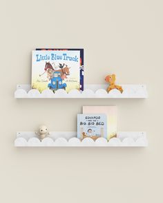 two white shelves with books and stuffed animals on them, each holding a story book