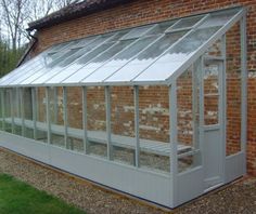 an old brick building with a white glass roof and windows on the side of it