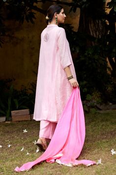 Baby pink three fourth sleeves straight kurta with floral embroidery on the placket and floral butta at the back. Paired with matching broad pant, bright pink tabby silk silver lumpi border dupatta and an inner.
Components: 4
Pattern: Embroidery
Type Of Work: Floral
Neckline: Mandarin Collar
Sleeve Type: Three Fourth
Fabric: Pure Chanderi, Tabby Silk 
Color: Pink
Other Details: 
Weight: 700gms
Length:
Kurta: 45inches
Sleeves: 17inches
Pant: 40inches
Model Height: 5ft 8inches, wearing size S
Note Kurta Pant Set, Straight Kurta, Embroidery Floral, Pattern Embroidery, Kurta With Pants, Pant Set, Mandarin Collar, Set For Women, Aza Fashion