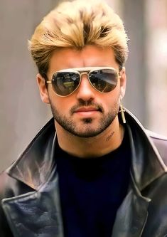 a man with blonde hair wearing sunglasses