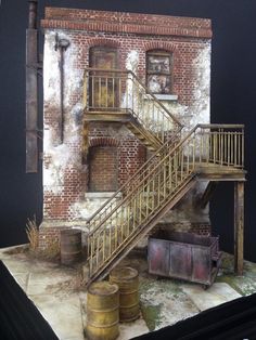 a model of a building with stairs and barrels